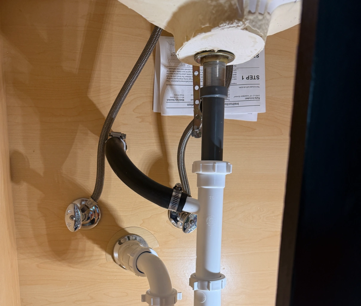 Undersink plumbing with a chrome valve photo